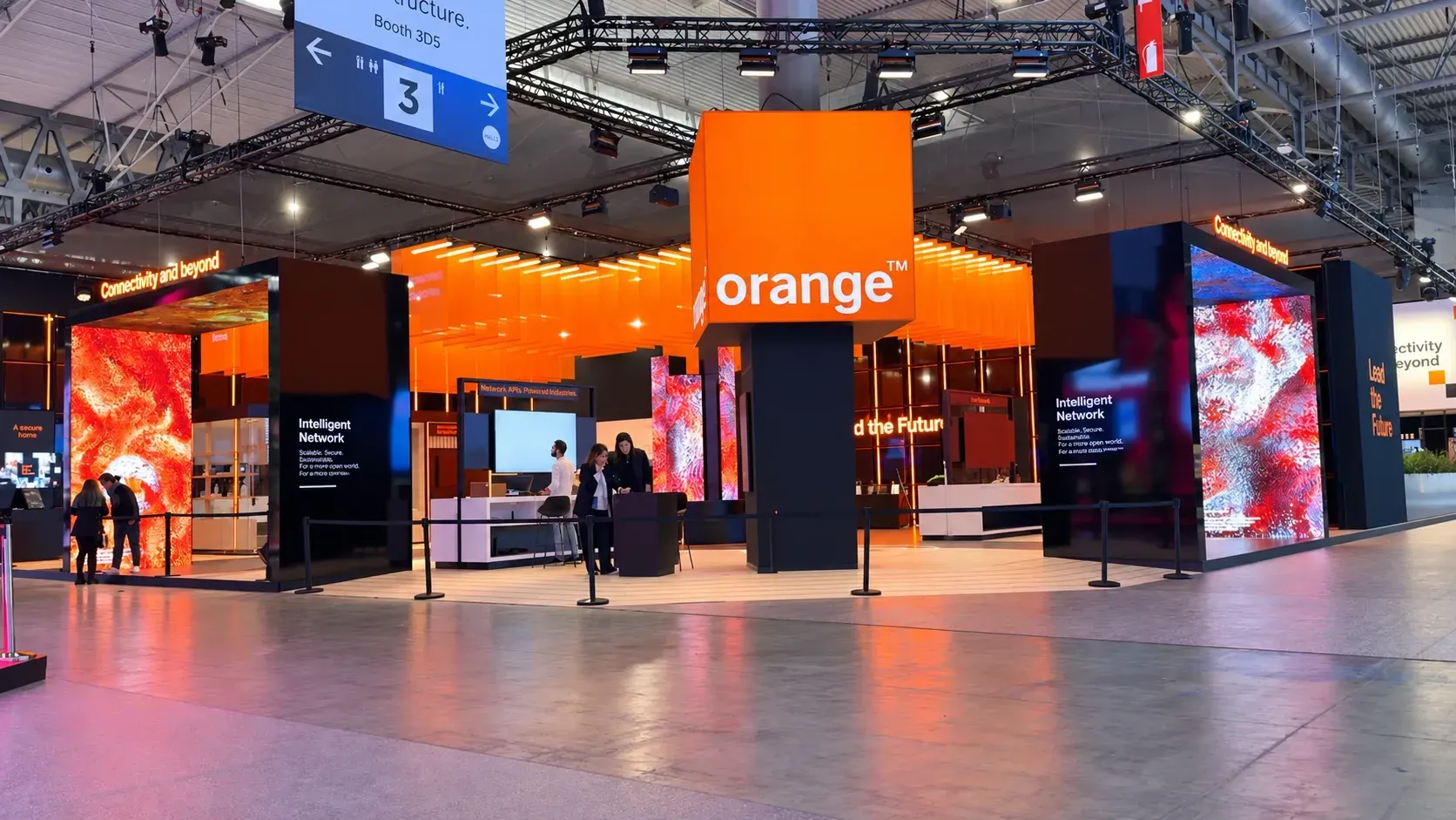 Wide view of the Orange MWC25 booth and LED installations