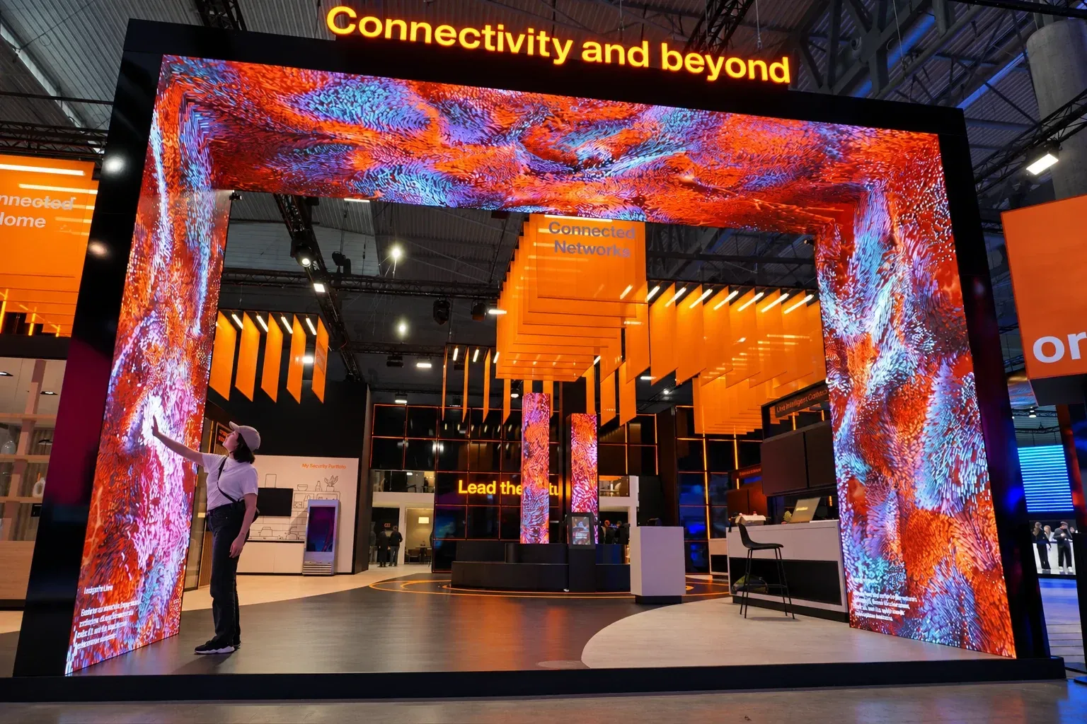 Orange MWC25 LED gateway displaying orange and blue data artwork